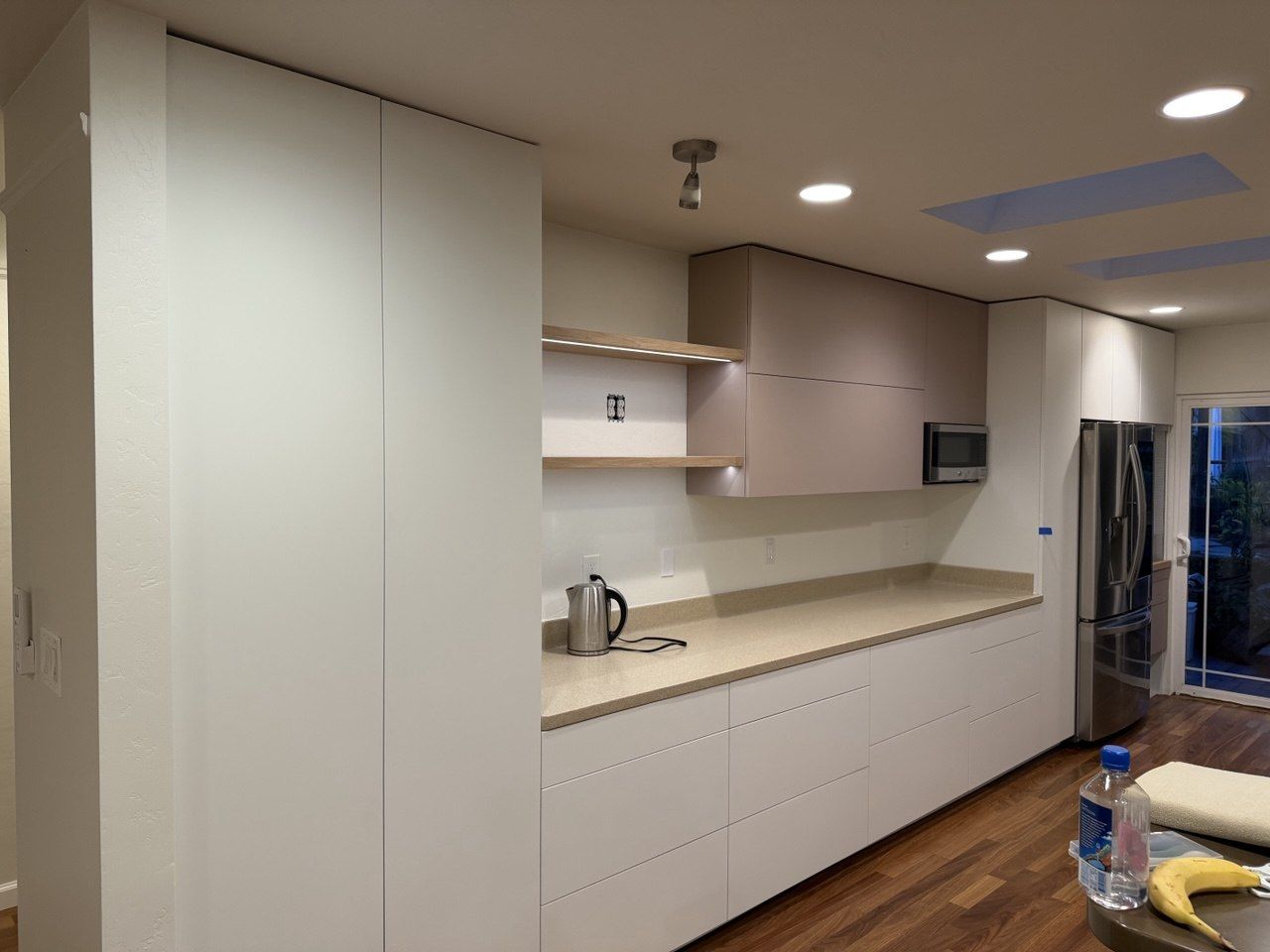 Handleless white kitchen with tall pantry wall
